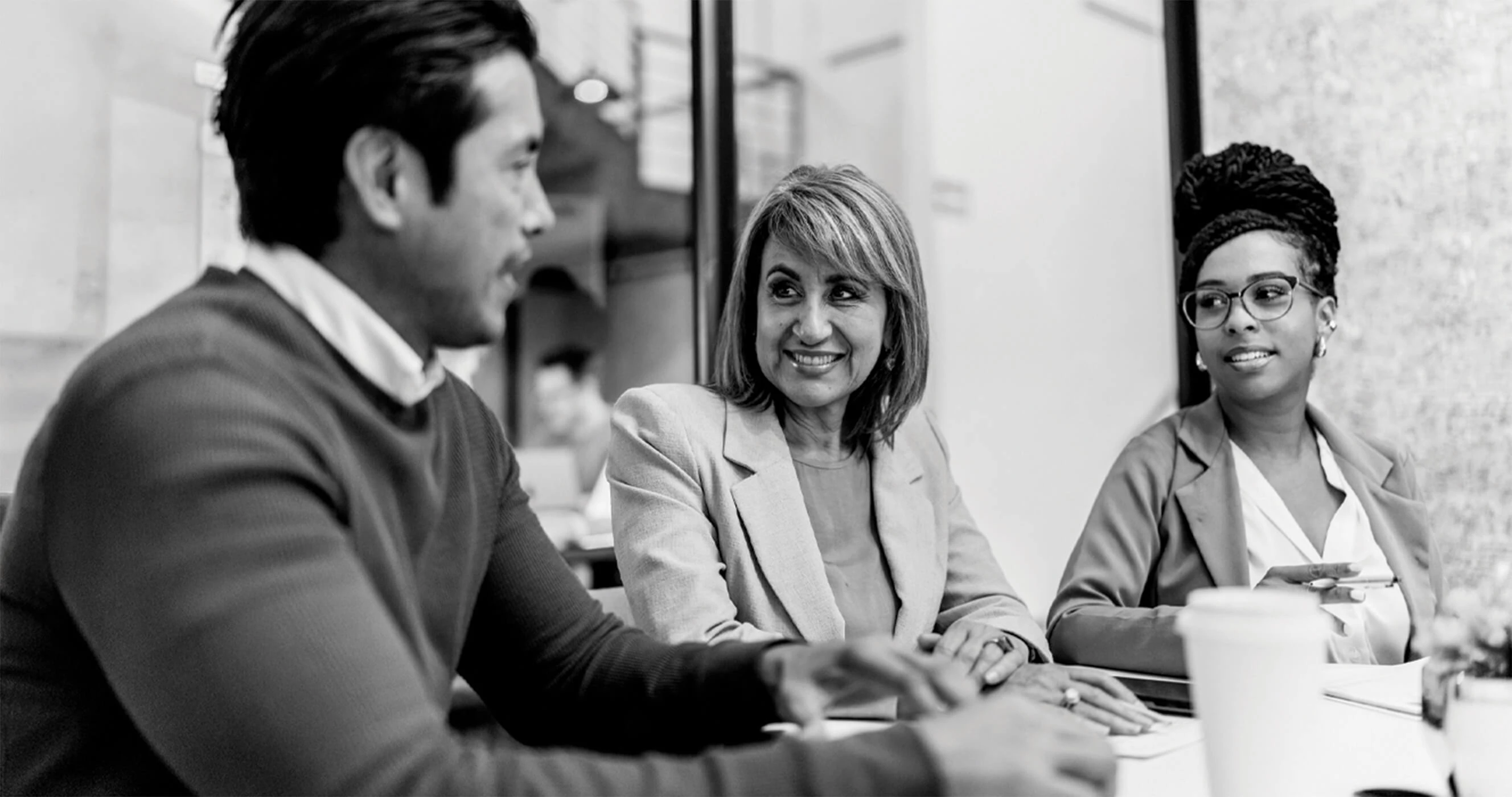 Associates gathered in a room for a meeting