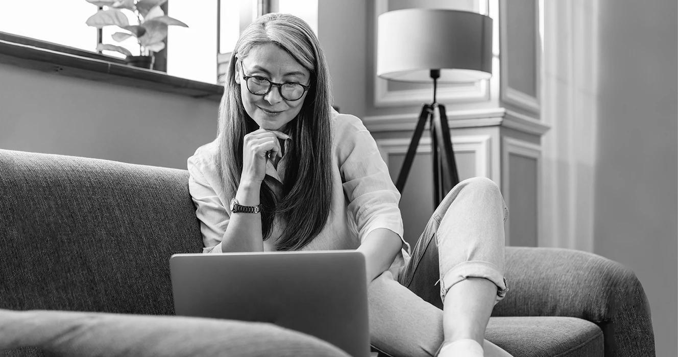 A woman reading an article on security planning on her laptop